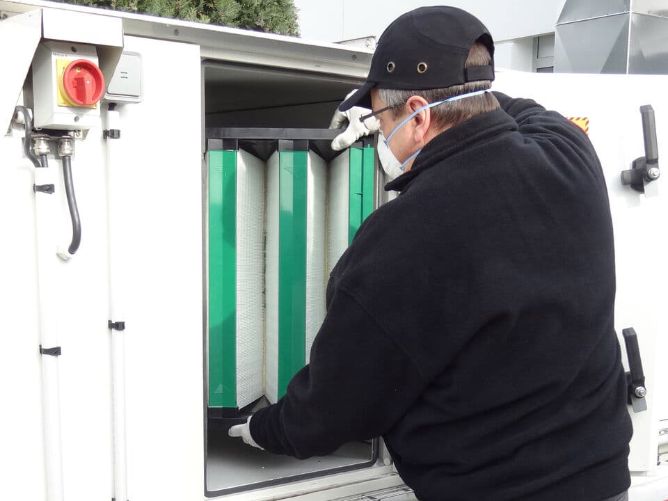 A man replacing a filter.