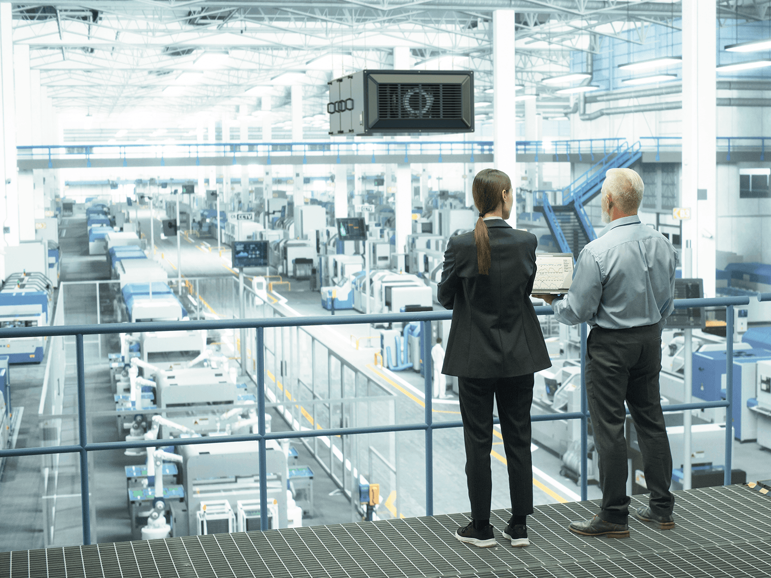 A woman and a man visiting a factory with Camfil filter solutions