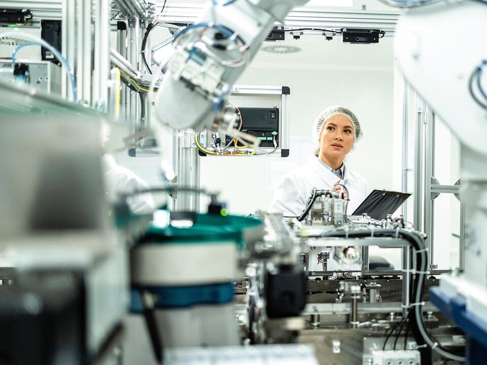Female engineer inspecting a production line