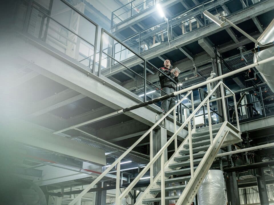 Man inside a factory holding an ipad