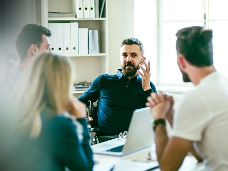 Group of people having a discussion in a room