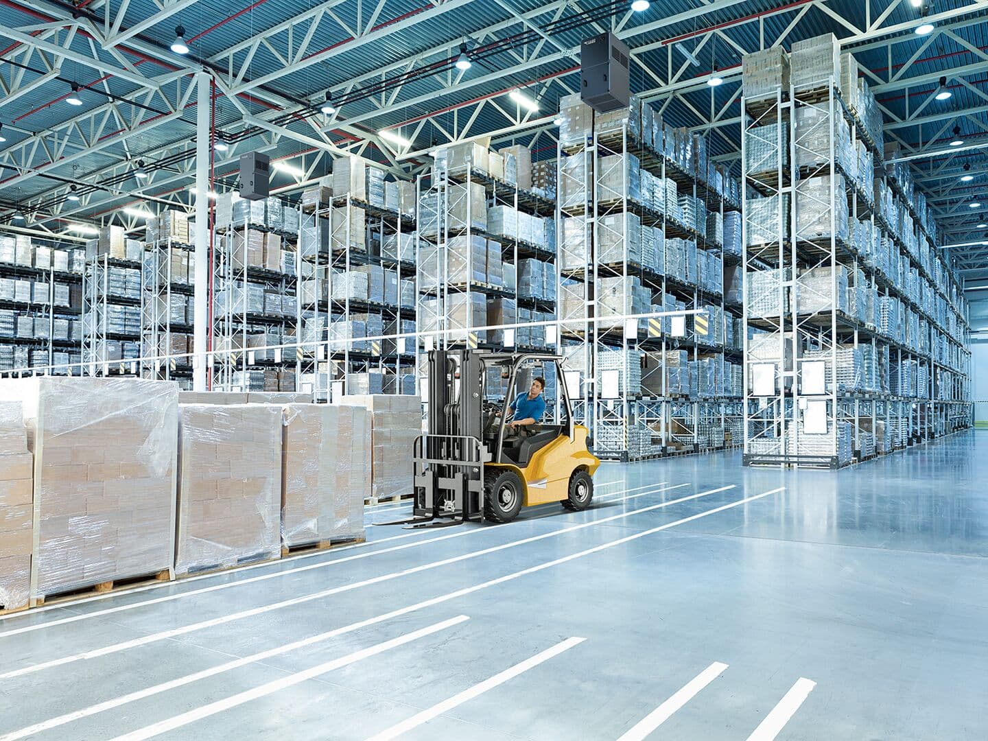 Forklift with employee in warehouse