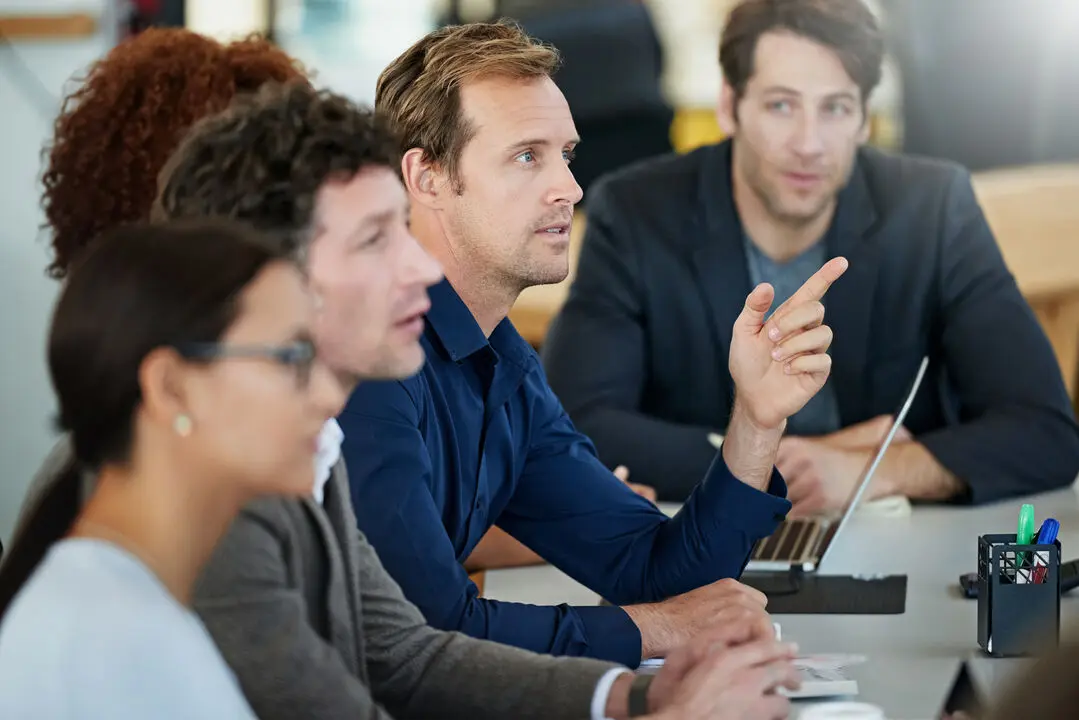 A man giving a presentation to a group of attentive listeners