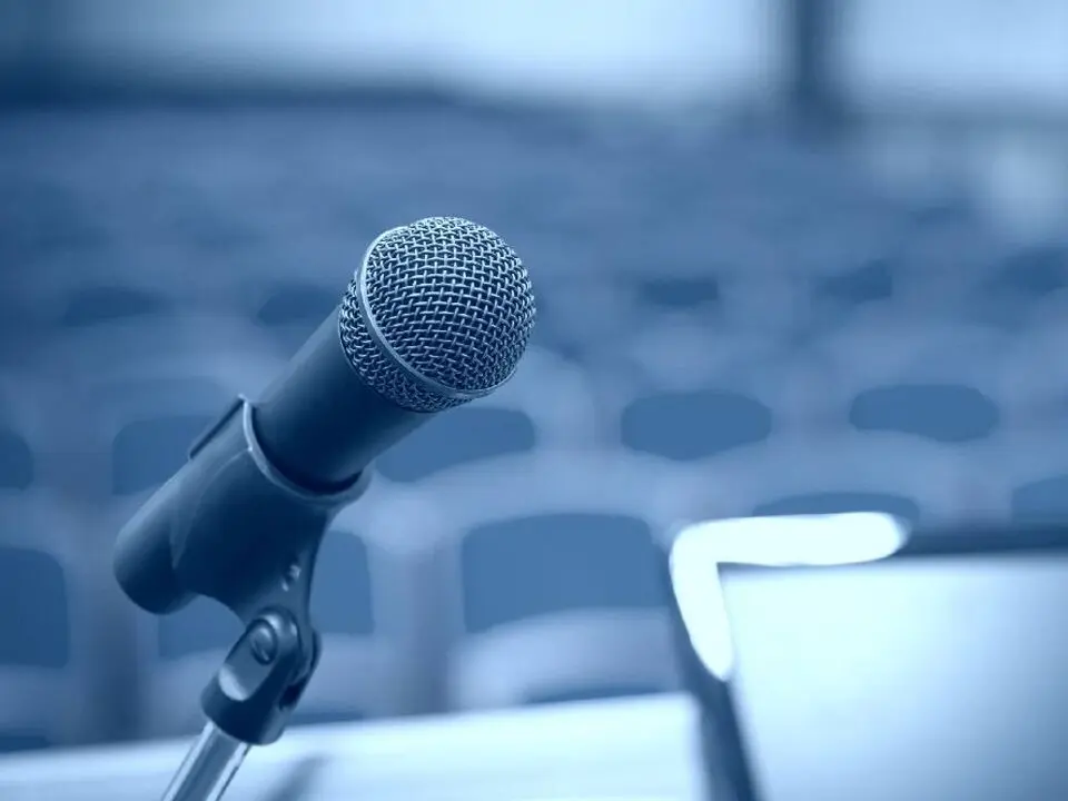 Microphone with conference hall in the background.