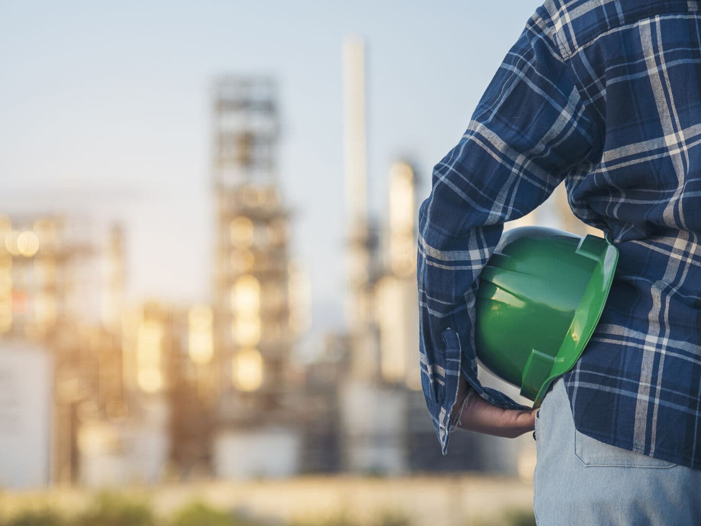 Woman engineer holding Green hard hats safety officer or inspector. Eco sustainable worker hands holding hardhat green work helmet Engineering. Woman Green business ecosystem environment engineering