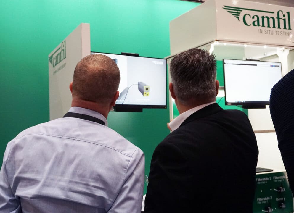 People at an expo looking at a Camfil test rig