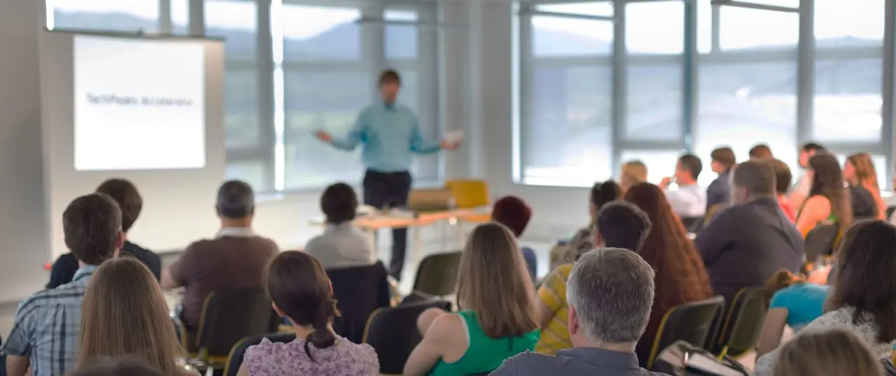 A man giving a presentation to a group of attentive listeners