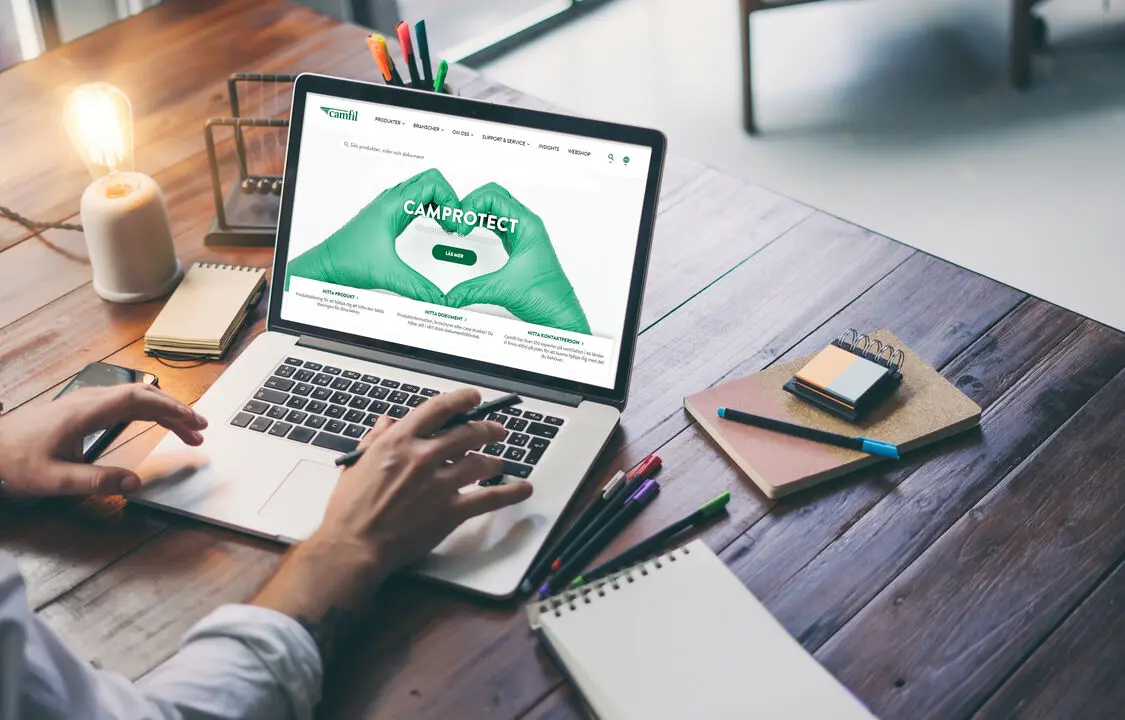 A person working on a laptop at a desk