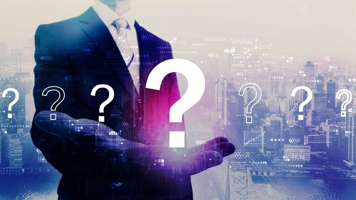 Question marks with businessman on a city background