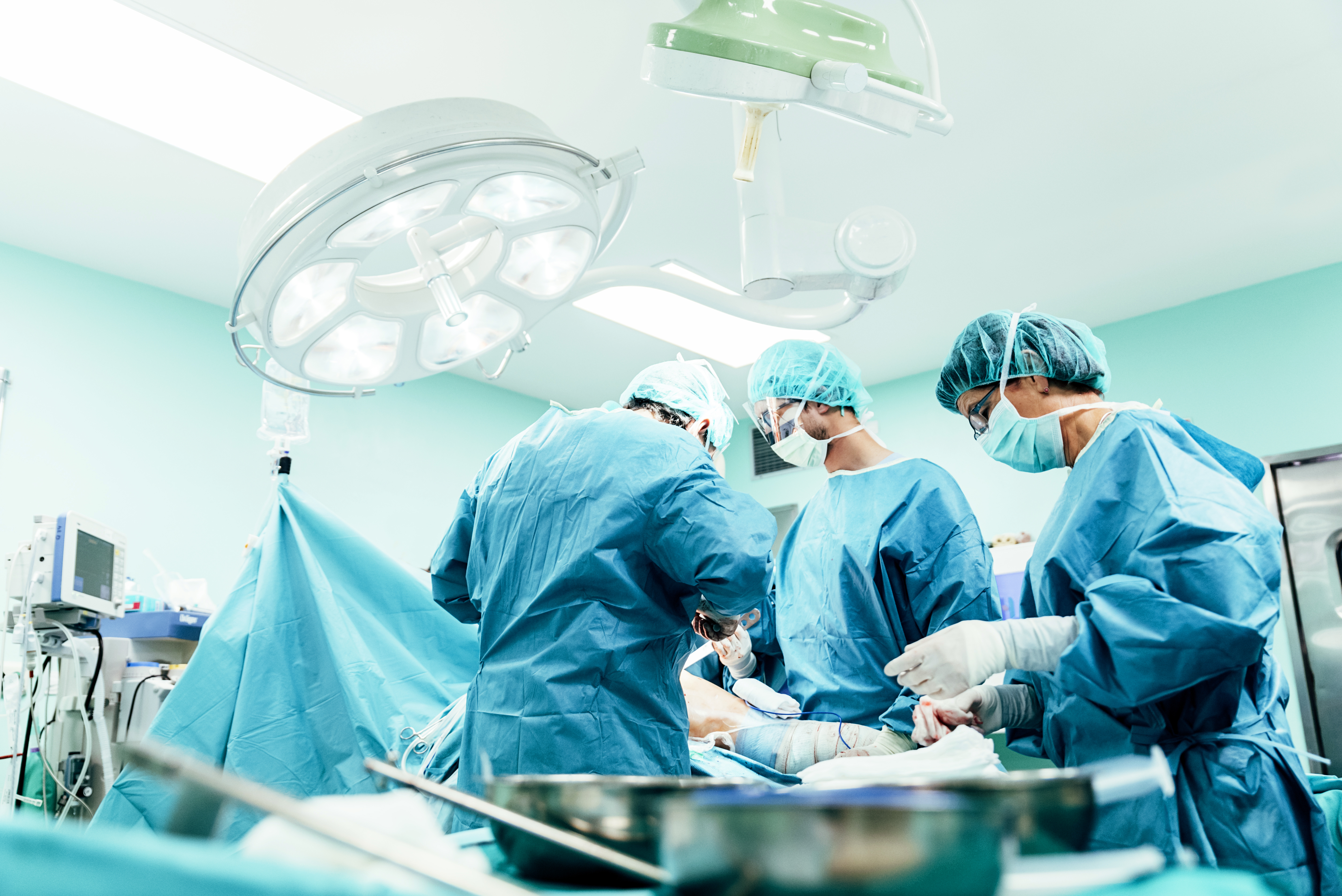 Medical Team Performing Surgical Operation in Bright Modern Operating Room
